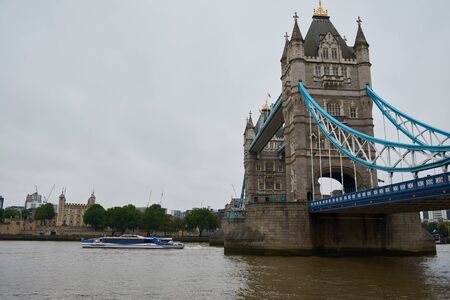 London, United Kingdom - June 10 2019: Tower Bridge above River Thames in rainy day. Historical and...