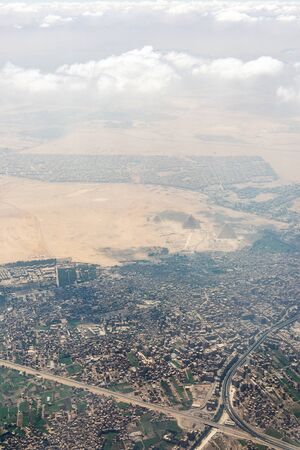 The Giza pyramid complex, also called the Giza Necropolis viewed from airplane window. Khufu,...