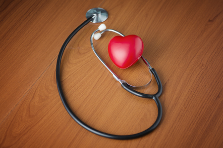 Love shape and stethoscope on wooden surfaceの写真素材