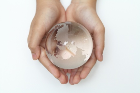 Glass globe in hand の写真素材