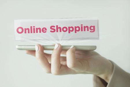 Close-up Of young businesswoman's hand holding smartphone with Online Shopping wordの写真素材