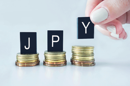 Currency Concept: JPY (Japanese Yen) text stacked on coins with cool image temperature の写真素材