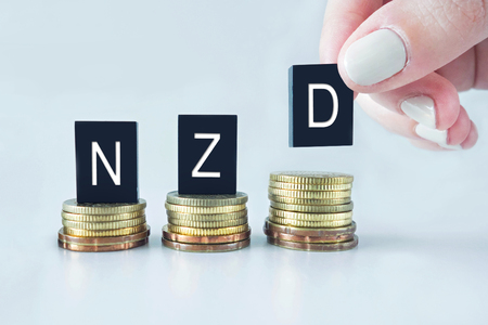 Currency Concept: NZD (New Zealand Dollar) text stacked on coins with cool image temperature の写真素材