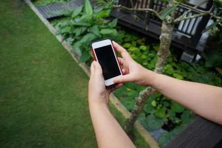 Girl using smartphone outdoorの写真素材