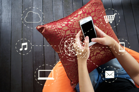 Woman using smartphone with network connection interfaceの写真素材