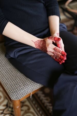 a beautiful red henna on a woman handの写真素材