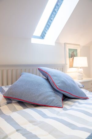 two blue pillow on a bed