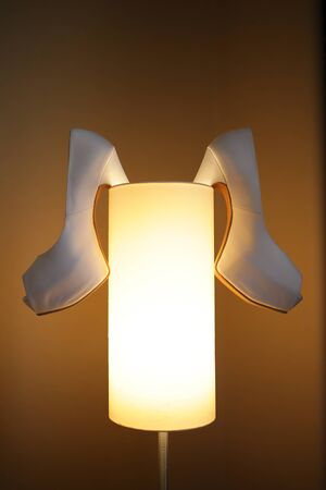 a bride shoe hanging on lampの写真素材