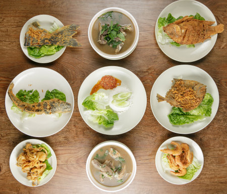 flat lay of malaysian food. Fried fish, fried chicken, fried prawn and fried squid.