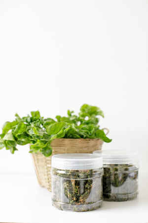 a bottle of fried brazilian spinach and a basket of brazilian spinachの写真素材