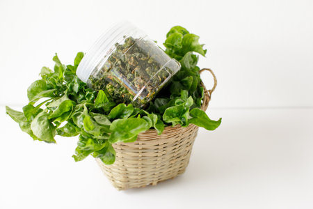 a bottle of fried brazilian spinach and a basket of brazilian spinachの写真素材
