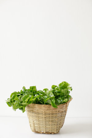 a basket of brazilian spinach on white background