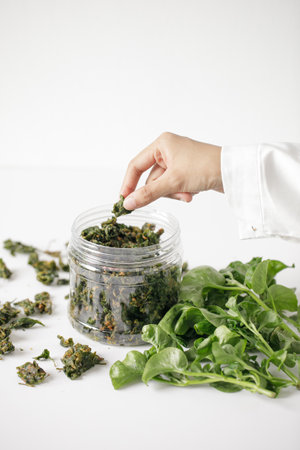 a lady picking a fried brazilian spinach