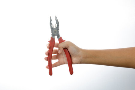 a man hand holding a pliers isolate on white backgroundの写真素材