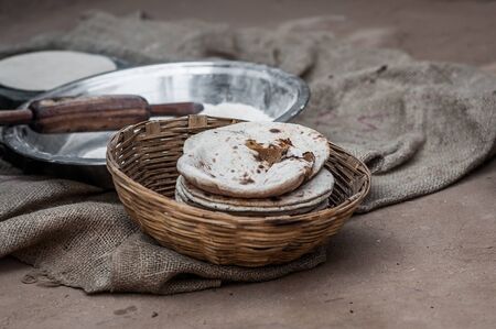 A shot of a home cooked flat breads in a rattan basket.