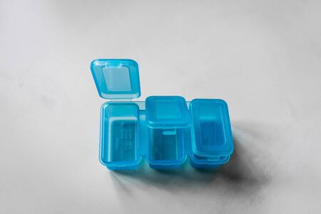 A shot of blue medication containers shot on a white background.の写真素材