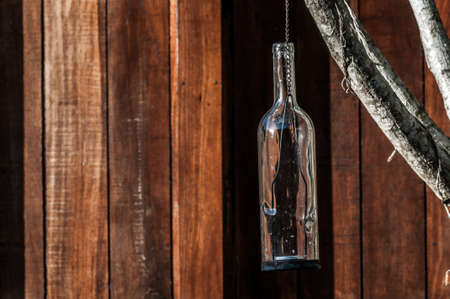 A shot of a glass bottle used as a candle holder.の写真素材