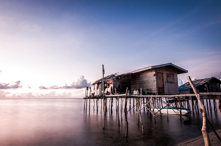 A long exposure shot of houses built on stilts taken during sunset. The shot was taken at one of the islands in Sabah, Malaysia.の写真素材