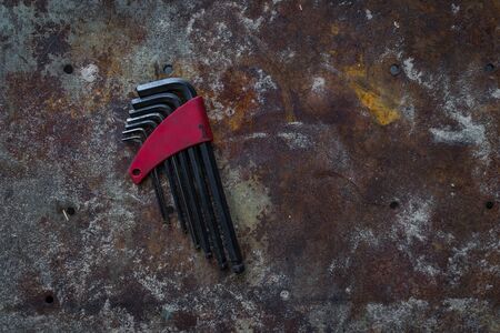 A shot of a set of Allen Keys on a rustic surface.