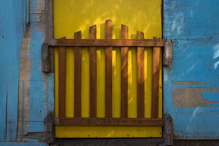 A shot of colourful house with a wooden gate.の写真素材