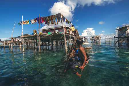 Denawan Island, Sabah Malaysia - April 30, 2016 : A shot of a group of children in a wooden boat...