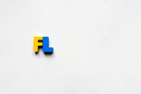 A shot of colorful alphabets over a white background.の写真素材