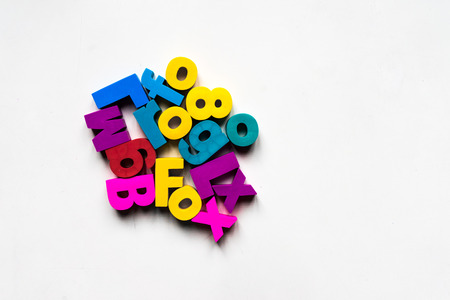 A shot of colorful alphabets over a white background.の写真素材