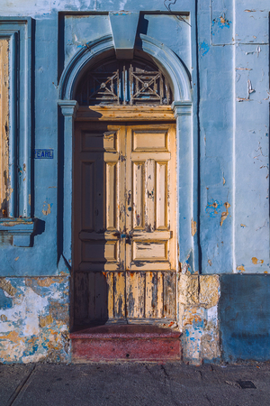 Shot of a wooden door on colorful textured wall. The shot was taken at Malta.の写真素材