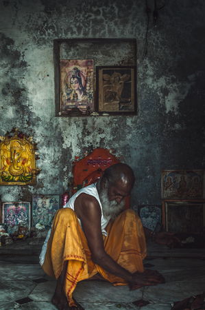 Pushkar, Rajasthan India - February 16, 2015 : A shot of a person cleaning the floor of a mini worship place.The shot was taken at Pushkar, India.のeditorial素材