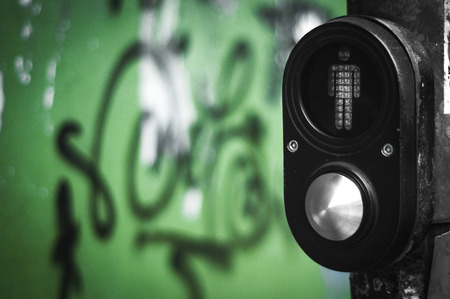 A shot of a traffic light pole with a button for pedestrian to cross. The shot was taken at Kuala...