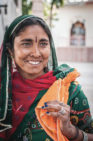 Pushkar, India : 17th February, 2015 - A shot of an Indian lady in traditional clothing smiles while looking away from the camera.のeditorial素材