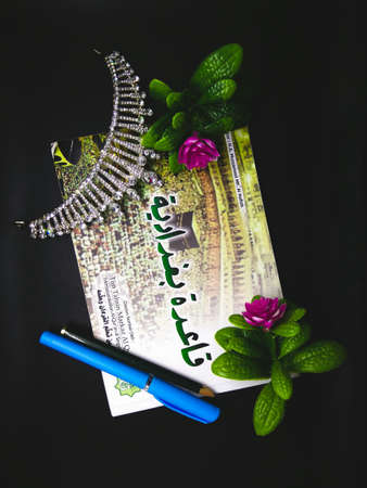 the crown with pen and flowers on black background.の写真素材