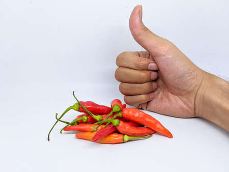Hand and fresh red chili peppers on white background isolated