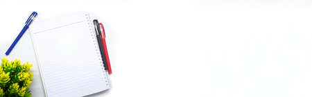 book, medical mask and pen decorated with flowers on white background. with the theme of back to school during a pandemic. perfect for cover and banner concepts. copy space, flat lay, top view.の写真素材