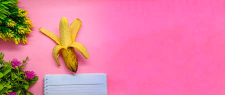 object with flowers decoration on soft pink background. with the theme of back to school during a pandemic. perfect for cover and banner concepts. copy space, flat lay, top view.の写真素材