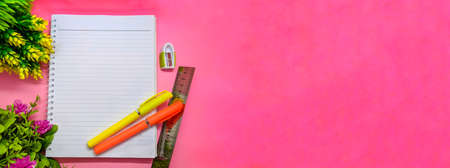 object with flowers decoration on soft pink background. with the theme of back to school during a pandemic. perfect for cover and banner concepts. copy space, flat lay, top view.の写真素材
