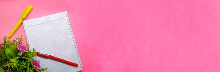 object with flowers decoration on soft pink background. with the theme of back to school during a pandemic. perfect for cover and banner concepts. copy space, flat lay, top view.の写真素材