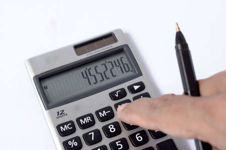 Close up photo of finger and calculator to calculate economy and finance