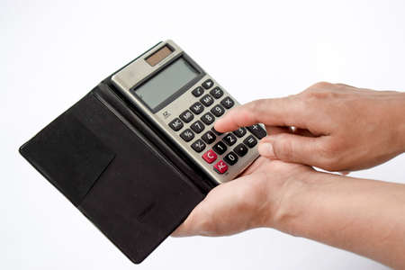 Close up photo of finger and calculator to calculate economy and finance