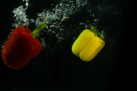 Photo of fresh vegetables falling in the water