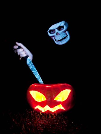 spooky skull killing jack-o-lanternの写真素材