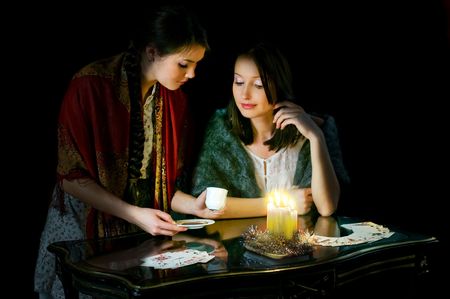 Christmastide fortune-telling: two girls reading coffee groundsの写真素材