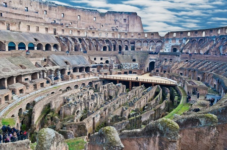 Internal wide angle view of Roman Colosseum (Flavian Amphitheatre) showing passages under the arena, the corridors, the stands and the outer walls. Tourists milling around the walkways and terraces. のeditorial素材