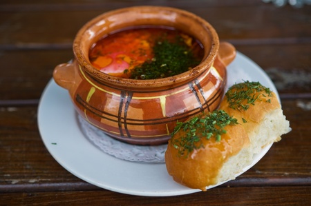 russian borscht served with bread on wooden tableの写真素材