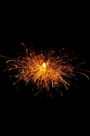 flames of a sparkles firework on black background
