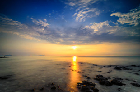 Awesome sunrise with marvelous clouds. Slow shutter used to create foamy & hazy effect.の写真素材