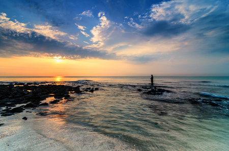 Awesome sunrise with marvelous clouds. Slow shutter used to create foamy & hazy effect.の写真素材