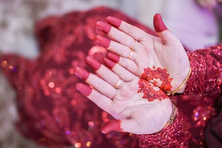 Very beautiful and unique henna paintings are on both hands of the bride.の写真素材