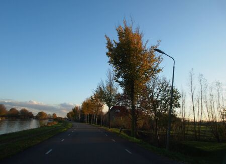 Quite sub-urban river side roadの写真素材
