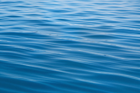 Blue water surface as a background. Texture of the water surface.の素材